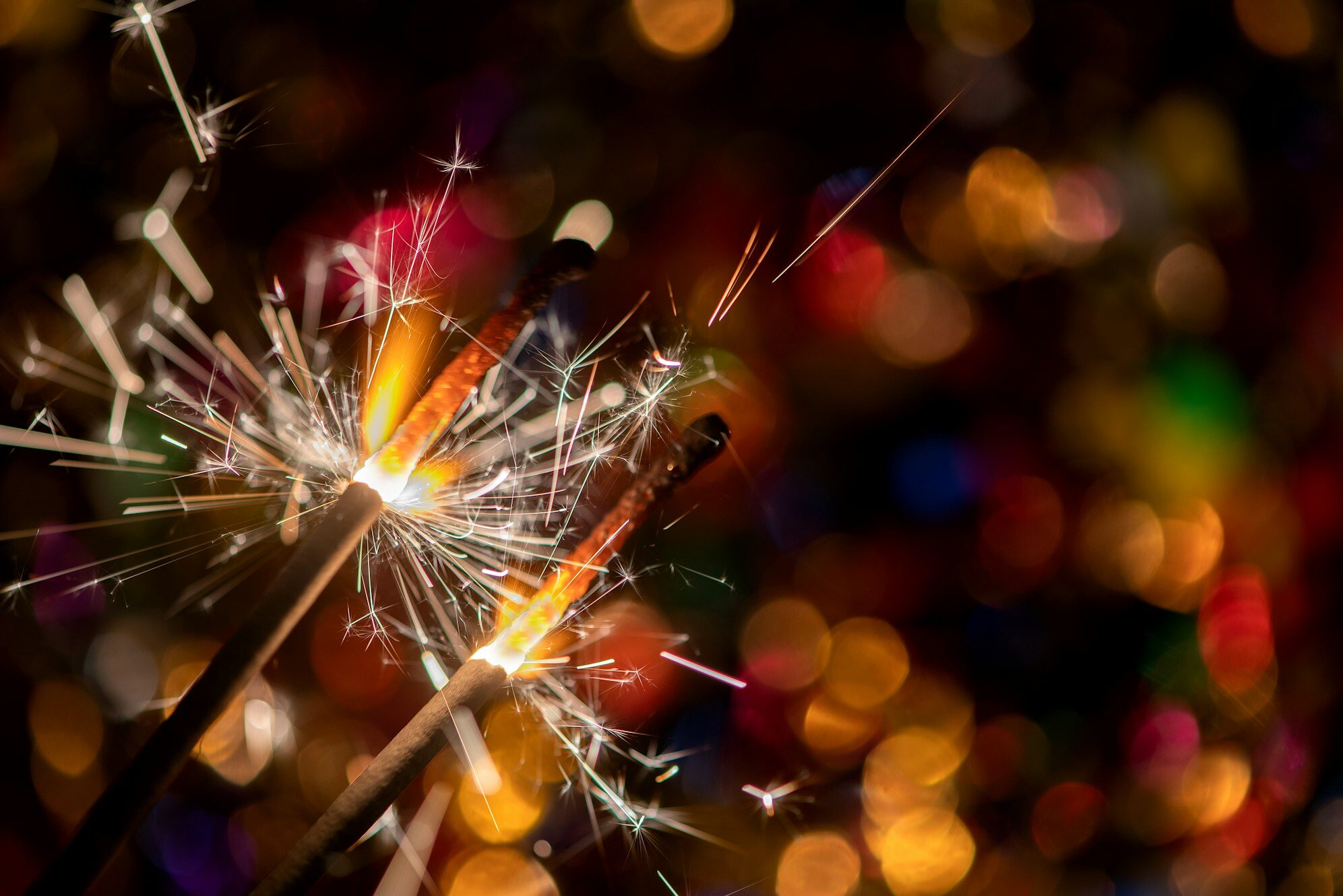 Glowing holiday sparkling hand fireworks shining fire flame christmas light abstract background e1714234839759